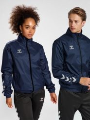 Kurtka ortalionowa piłkarska dla dorosłych Hummel Core XK Spray Jacket. Niebieskie kurtki damskie HUMMEL, m, bez wzorów, z materiału, z kapturem. Za 181.65 zł.