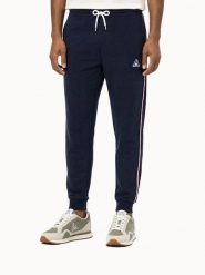 Spodnie Le Coq Sportif Tri SP. Niebieskie spodnie sportowe męskie Le Coq Sportif, z materiału. Za 403.00 zł.