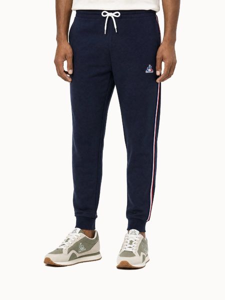 Spodnie Le Coq Sportif Tri SP. Niebieskie spodnie sportowe męskie Le Coq Sportif, z materiału. Za 403.00 zł.