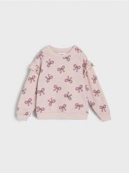 Bluza we wzór w kokardy - różowy. Czerwone bluzy i bluzki niemowlęce Sinsay, bez wzorów, bez ramiączek, bez kaptura. Za 15.99 zł.