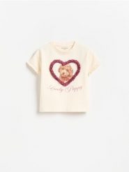 T-shirt z nadrukiem i aplikacją - kremowy. Białe koszulki dziewczęce Reserved, m, z aplikacjami, z bawełny, bez ramiączek. Za 35.99 zł.