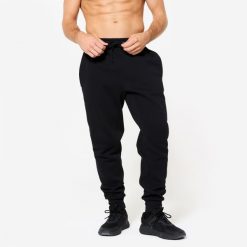 Spodnie fitness męskie Domyos Gym & Pilates slim. Niebieskie spodnie dresowe męskie DOMYOS, z dresówki. Za 79.99 zł.
