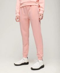 Superdry Spodnie Sports Tech Slim – slim fit, Peach Pearl Pink. Czerwone spodnie sportowe damskie Superdry., z bawełny. Za 274.55 zł.