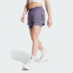 Szorty Own the Run Climacool 2-in-1. Fioletowe spodenki sportowe damskie Adidas, bez wzorów, sportowe. W wyprzedaży za 165.17 zł.
