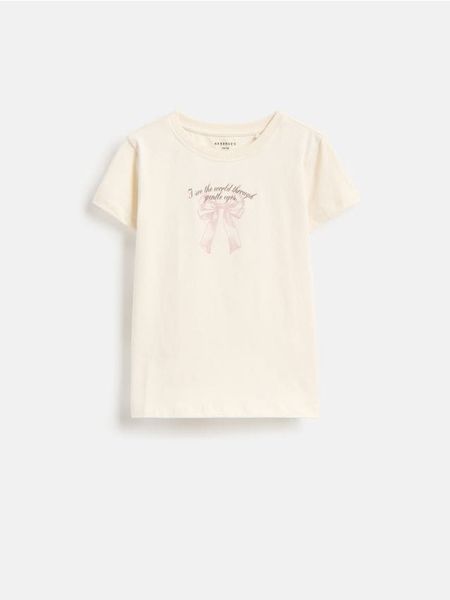 T-shirt z nadrukiem - kremowy. Białe koszulki dziewczęce Reserved, bez wzorów, z bawełny, bez ramiączek. Za 19.99 zł.