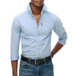 Wyblakana koszula Superdry Oxford. Niebieskie koszule męskie Superdry., xl, bez wzorów, z bawełny, bez kołnierzyka, bez ramiączek. Za 308.40 zł.