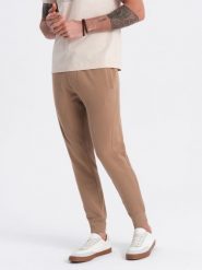 Spodnie męskie dresowe typu jogger - brązowe V2. Brązowe spodnie dresowe męskie Ombre Clothing, bez wzorów, z bawełny. W wyprzedaży za 101.24 zł.