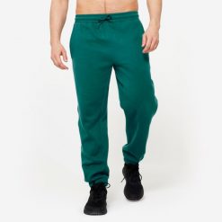 Spodnie dresowe męskie Gym & Pilates - turkusowe. Niebieskie spodnie sportowe męskie DOMYOS, z bawełny. W wyprzedaży za 69.99 zł.