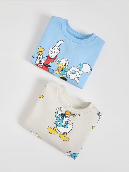 Bluza Mickey Mouse 2 pack - jasnoniebieski. Niebieskie bluzy i bluzki niemowlęce Reserved, bez wzorów, z bawełny, bez ramiączek, bez kaptura. W wyprzedaży za 55.99 zł.