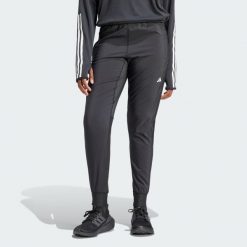 Spodnie Own the Run. Czarne spodnie dresowe damskie Adidas, s, z materiału, do biegania. W wyprzedaży za 168.35 zł.