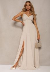 Beżowa Elegancka Sukienka o Rozkloszowanym Kroju z Rozcięciem na Ramiączkach z Kopertowym Dekoltem Winelia. Brązowe sukienki damskie Renee, l, bez wzorów, eleganckie, bez kołnierzyka, bez ramiączek, maxi, kopertowe. W wyprzedaży za 125.99 zł.