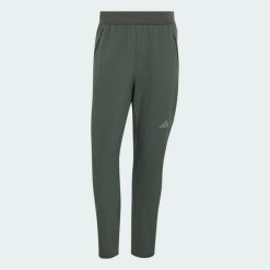 SPODNIE D4T CLIMAWARM. Zielone spodnie materiałowe męskie Adidas, bez wzorów, z elastanu, eleganckie, z standardowym stanem. Za 439.00 zł.