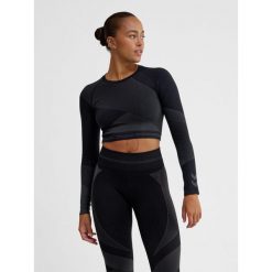 Damska bluzka treningowa bezszwowa z długim rękawem Hummel. Niebieskie bluzki sportowe damskie HUMMEL, z materiału, bez kołnierzyka, bez ramiączek. Za 177.00 zł.