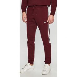 Adidas Originals - Spodnie. Brązowe spodnie materiałowe męskie adidas Originals, bez wzorów, z bawełny, casualowe. W wyprzedaży za 219.90 zł.