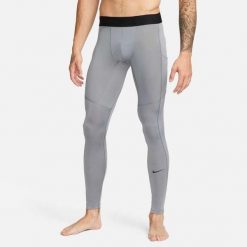 Legginsy męskie Nike Dri-FIT Fitness Tights. Szare spodnie sportowe męskie Nike, z poliesteru. Za 188.50 zł.