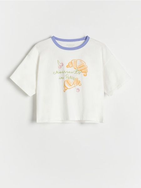 T-shirt z aplikacją - niebieski. Niebieskie koszulki dziewczęce Reserved, z aplikacjami, z bawełny, bez ramiączek. W wyprzedaży za 12.99 zł.