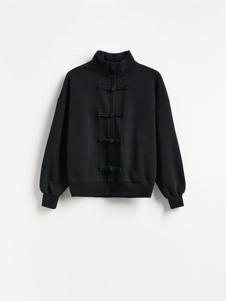 Bluza z ozdobnym zapięciem - czarny. Czarne bluzy bez kaptura damskie Reserved, l, z bawełny. Za 139.99 zł.