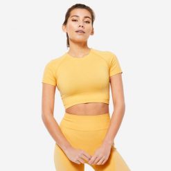 Koszulka fitness damska Domyos krótki rękaw. Czarne bluzki sportowe damskie DOMYOS, l, bez wzorów, z materiału, bez ramiączek. W wyprzedaży za 59.99 zł.