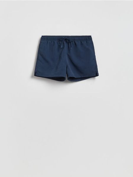 Gładkie szorty plażowe - granatowy. Niebieskie szorty męskie Reserved, z tkaniny, bez kołnierzyka. Za 59.99 zł.
