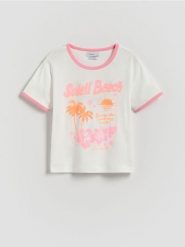T-shirt z brokatowym nadrukiem - złamana biel. Koszulki dziewczęce Reserved, bez wzorów, z bawełny, bez ramiączek. W wyprzedaży za 25.99 zł.