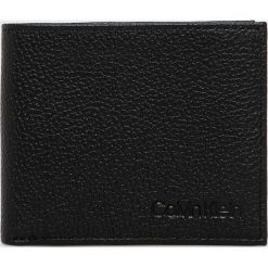 Calvin Klein - Portfel skórzany. Czarne portfele męskie CALVIN KLEIN, bez wzorów, z materiału. W wyprzedaży za 159.90 zł.