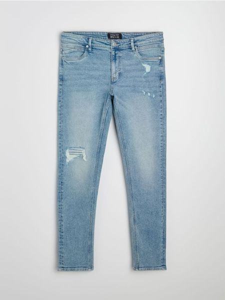 Jeansy slim fit z przetarciami i efektem sprania - niebieski. Niebieskie jeansy męskie Sinsay. Za 79.99 zł.