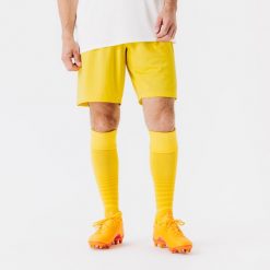 Spodenki piłkarskie Kipsta Essential. Żółte szorty damskie KIPSTA, bez wzorów, z materiału, sportowe. Za 29.99 zł.
