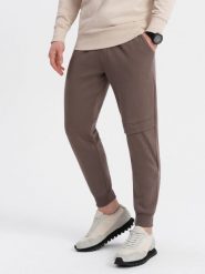 Spodnie męskie dresowe z przeszyciem i zamkiem na nogawce - brązowe V4. Brązowe spodnie dresowe męskie Ombre Clothing, bez wzorów, z bawełny. W wyprzedaży za 69.99 zł.