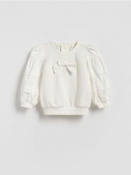 Bluza z bufiastymi rękawami - złamana biel. Bluzy i bluzki niemowlęce Reserved, bez wzorów, z bawełny, bez ramiączek, bez kaptura. Za 49.99 zł.