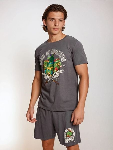 Bawełniana piżama dwuczęściowa z nadrukiem Teenage Mutant Ninja Turtles - szary. Szare piżamy męskie Sinsay, l, bez wzorów, z bawełny, bez ramiączek. Za 49.99 zł.