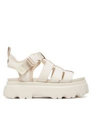 Ugg Sandały W Cora 1152698 Écru. Sandały damskie Ugg, bez wzorów, z nubiku, bez obcasa, na płaskiej podeszwie. Za 509.99 zł.