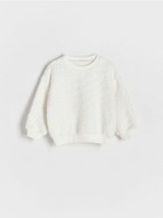 Bluza z cekinami - złamana biel. Bluzy i bluzki niemowlęce Reserved, bez wzorów, z dzianiny, bez ramiączek, bez kaptura. W wyprzedaży za 35.99 zł.