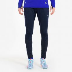 Spodnie piłkarskie Kipsta CLR. Niebieskie spodnie materiałowe męskie KIPSTA, bez wzorów, z materiału, sportowe. Za 89.99 zł.