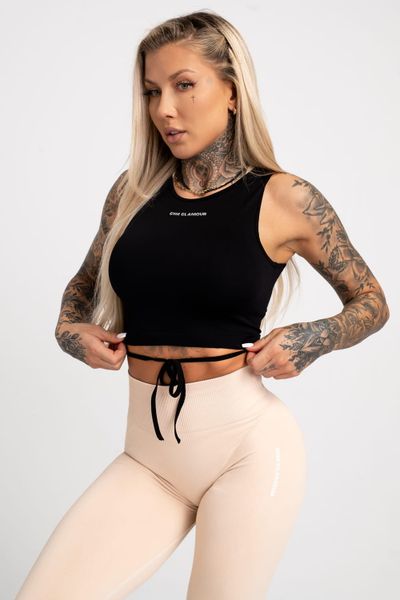 Top fitness damski Gym Glamour wiązany. Czarne topy sportowe damskie GYM GLAMOUR, l, bez wzorów, z materiału, bez ramiączek. Za 99.99 zł.