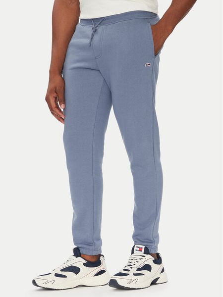 Tommy Jeans Spodnie dresowe Flag DM0DM20473 Niebieski Slim Fit. Niebieskie spodnie dresowe męskie Tommy Jeans, bez wzorów, z bawełny. Za 189.99 zł.