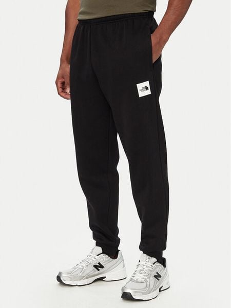 The North Face Spodnie dresowe Box Half Dome NF0A8JB0 Czarny Regular Fit. Czarne spodnie dresowe męskie The North Face, bez wzorów, z dresówki. Za 279.99 zł.