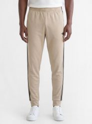 Adidas Originals spodnie do biegania Mężczyźni Sztuczne włókno beżowy, S. Brązowe spodnie materiałowe męskie adidas Originals, bez wzorów, z bawełny. Za 279.95 zł.