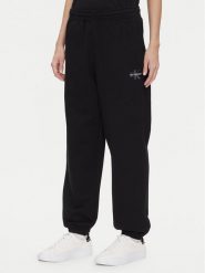 Calvin Klein Jeans Spodnie dresowe Monologo LV047B235G Czarny Regular Fit. Czarne jeansy damskie Calvin Klein Jeans, xl, bez wzorów, z bawełny. Za 269.99 zł.