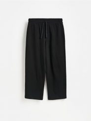 Spodnie baggy - czarny. Czarne spodnie materiałowe męskie Reserved, bez wzorów, z bawełny. Za 129.99 zł.