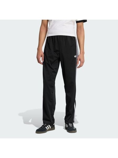 Adidas Spodnie dresowe Firebird KD8315 Czarny Loose Fit. Czarne spodnie dresowe męskie Adidas, bez wzorów, z dresówki. Za 278.99 zł.