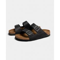 Klapki Birkenstock 552113. Czarne klapki damskie Birkenstock, bez wzorów, z materiału, bez obcasa. Za 525.05 zł.