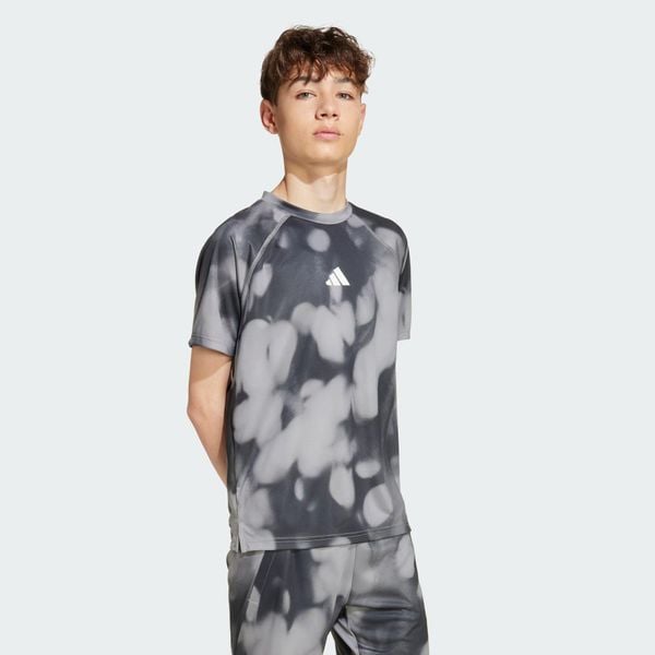 Koszulka treningowa z grafiką na całej powierzchni. Czarne bluzki damskie Adidas, uniwersalny, bez wzorów, sportowe, bez kołnierzyka, bez ramiączek. Za 129.00 zł.