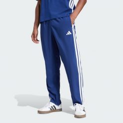 Spodnie Essentials 3-Stripes Stanford Open Hem. Brązowe spodnie sportowe męskie Adidas, z materiału. Za 179.00 zł.