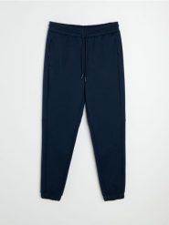 Spodnie tapered fit Active - granatowy. Niebieskie spodnie sportowe męskie Sinsay. Za 59.99 zł.