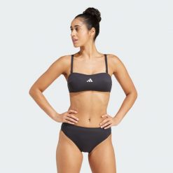 Koszulka typu bandeau Iconisea Padded. Białe t-shirty damskie Adidas, bez wzorów, z materiału, bez kołnierzyka. W wyprzedaży za 99.50 zł.