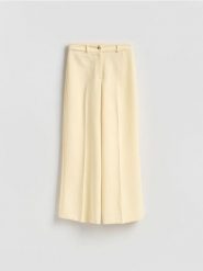 Luźne spodnie - jasnożółty. Żółte spodnie materiałowe damskie Reserved, bez wzorów, z tkaniny. Za 129.99 zł.