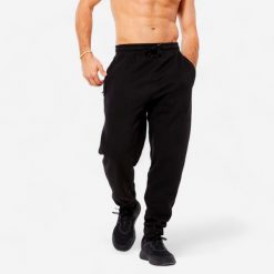 Spodnie dresowe męskie Domyos Gym & Pilates. Czarne spodnie sportowe męskie DOMYOS, z bawełny. Za 89.99 zł.