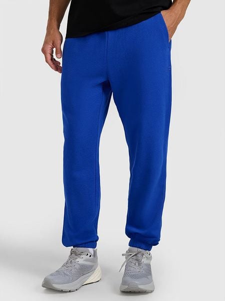 4F Spodnie dresowe w kolorze granatowym rozmiar: L. Niebieskie spodnie dresowe męskie 4f, bez wzorów, z dresówki. Za 84.21 zł.