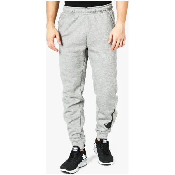 Nike Spodnie Therma Taper Swoosh , szary, rozmiar XL. Szare spodnie materiałowe męskie Nike, bez wzorów, z dresówki. W wyprzedaży za 159.99 zł.