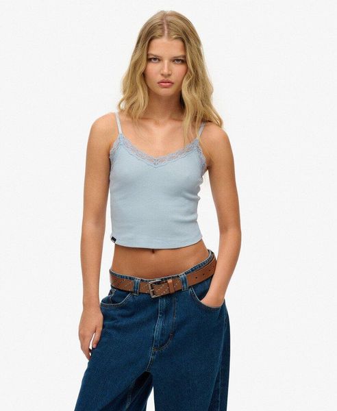 Krótki top z koronkowymi wykończeniami dla kobiet Superdry Athletic Essentials. Niebieskie topy sportowe damskie Superdry., l, bez wzorów, z koronki, bez ramiączek. Za 126.60 zł.